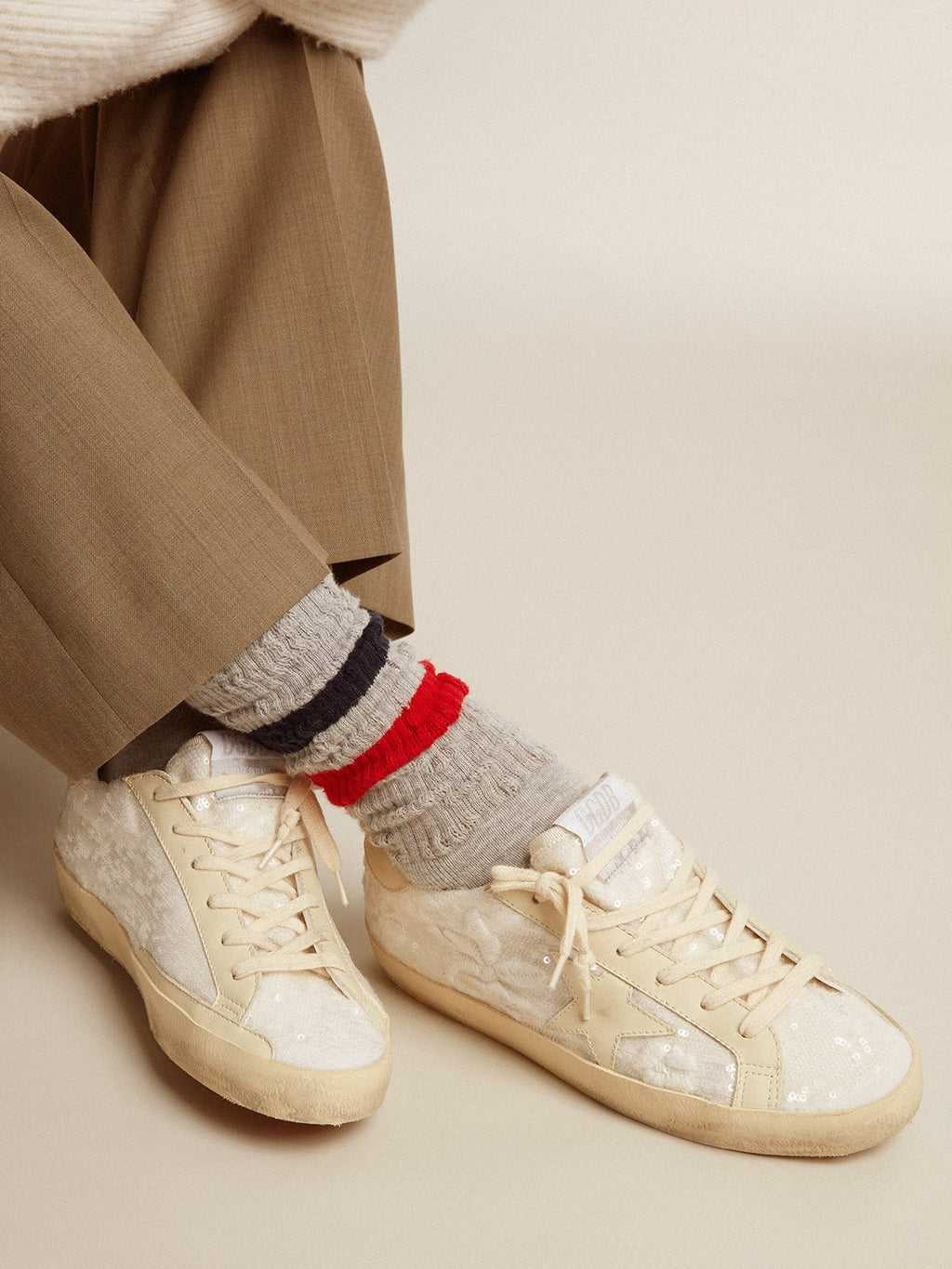 Gray socks with contrasting red and blue stripes and red logo