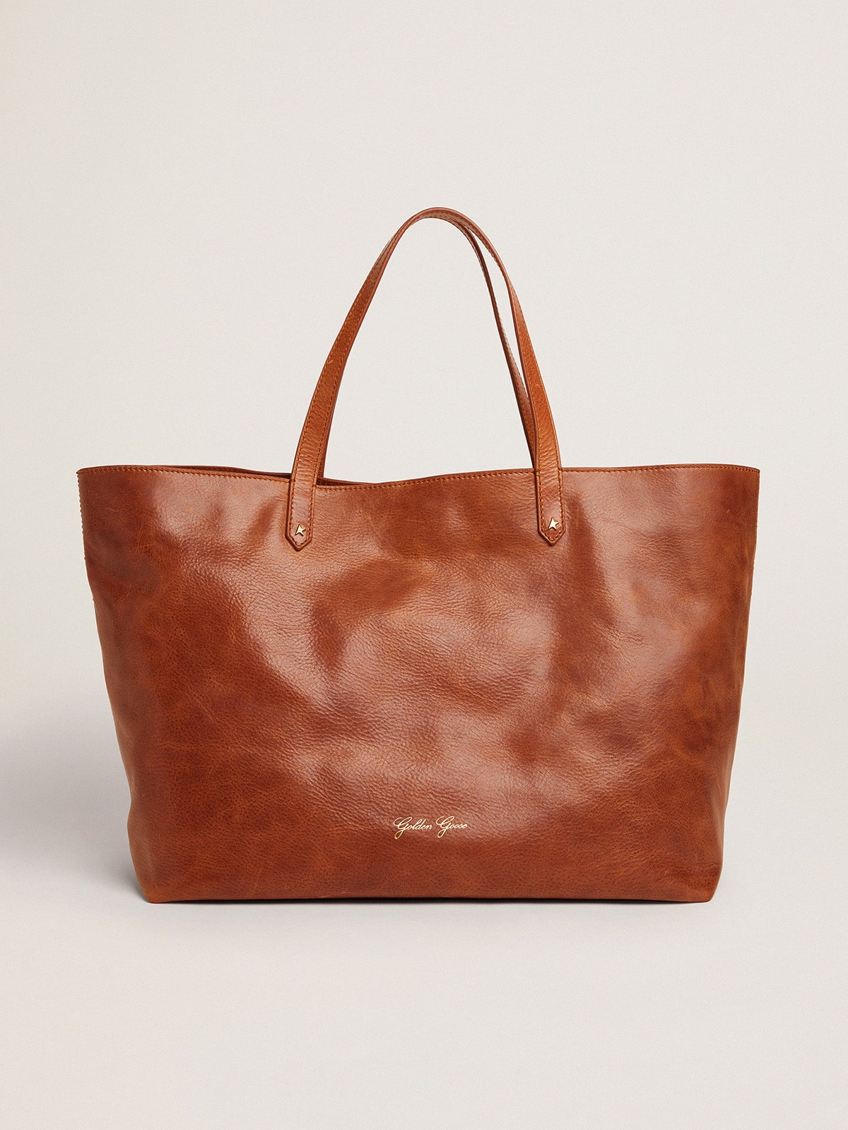 Pasadena Bag in tan-colored glossy hammered leather with gold logo on the front| Golden Goose