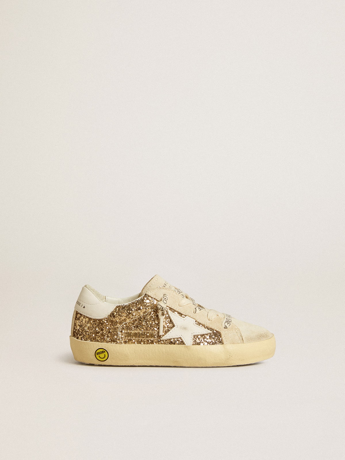 Super-Star Junior in gold glitter with white leather star and heel tab| Golden Goose