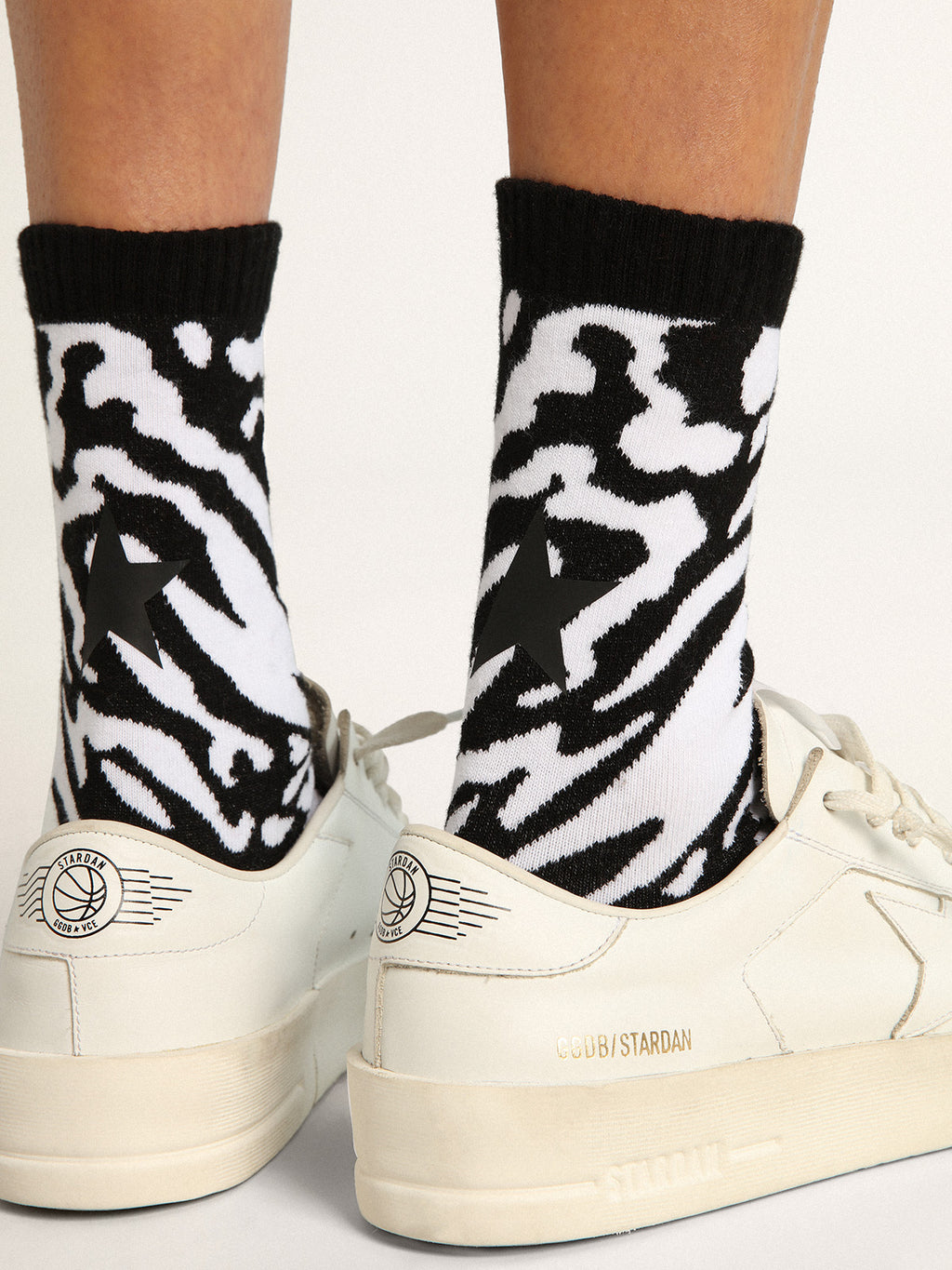 Black and white socks with leopard print and black star on the back| Golden Goose