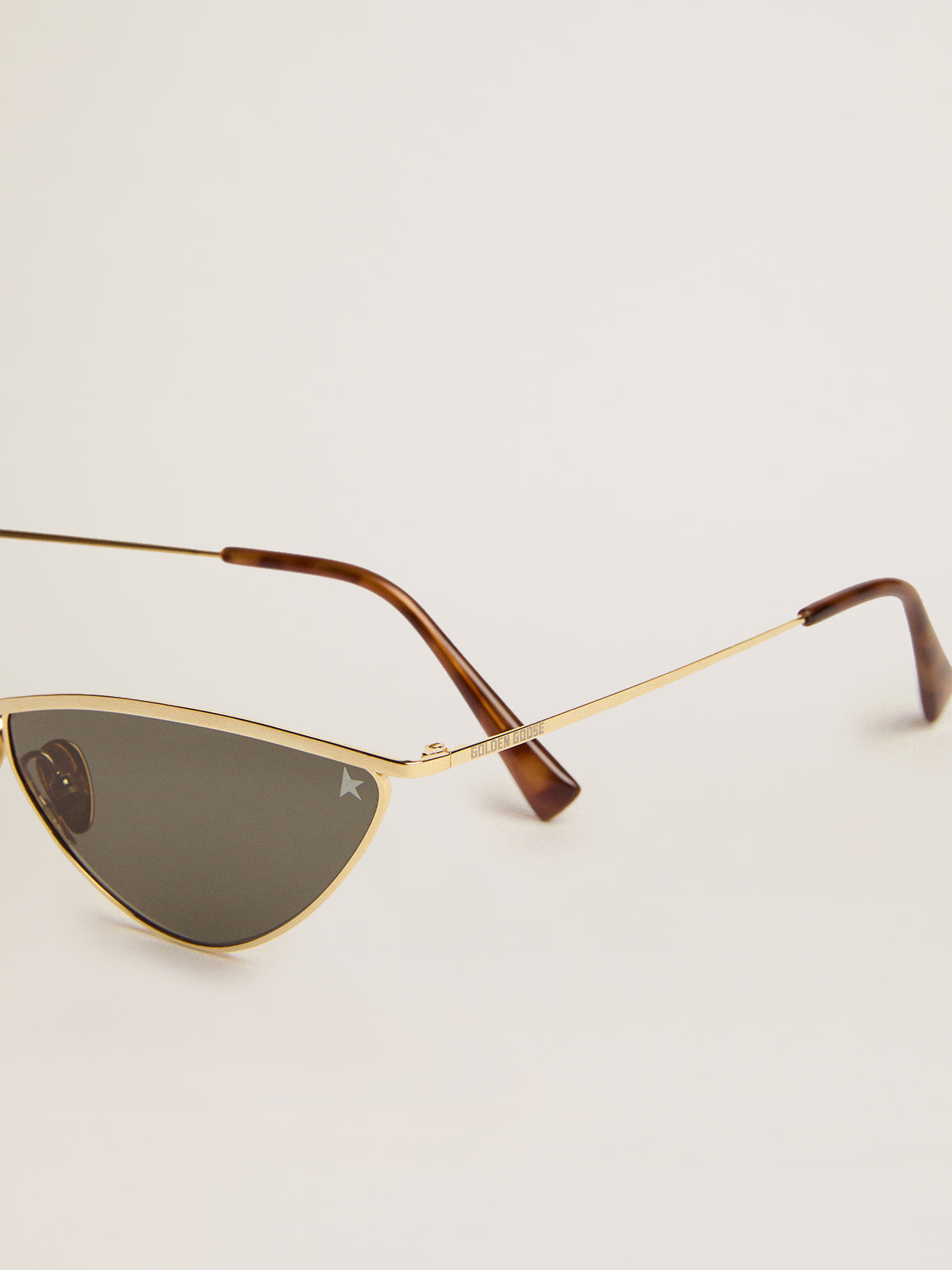 Sunglasses cat-eye style with gold frame and green lenses| Golden Goose