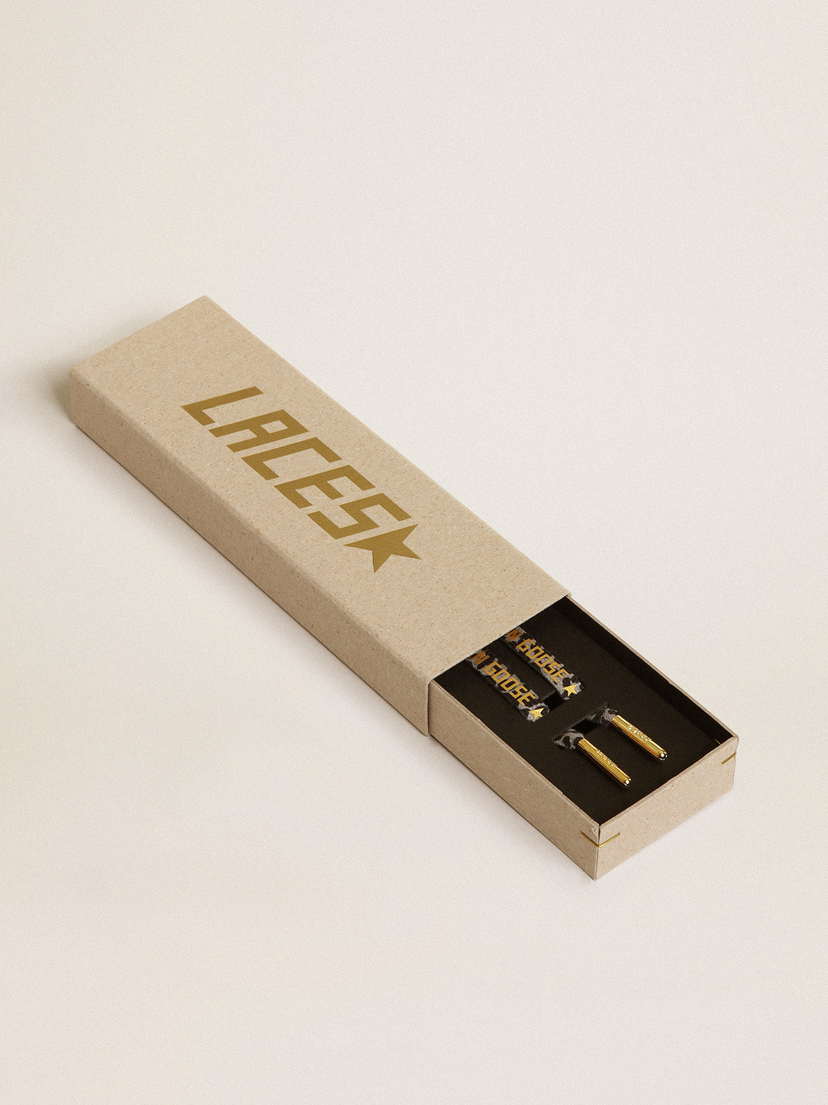 Black and white animal-print laces with contrasting gold-colored logo| Golden Goose