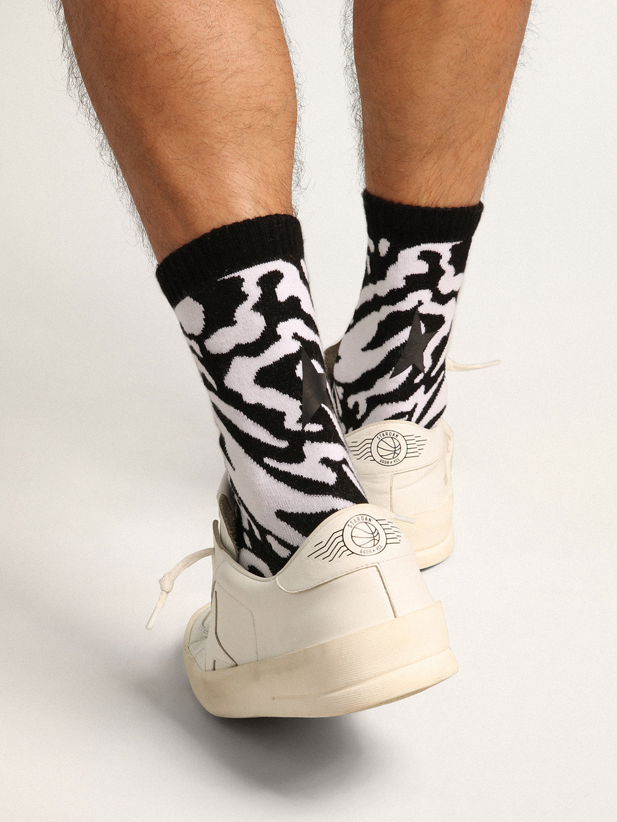 Black and white socks with leopard print and black star on the back| Golden Goose