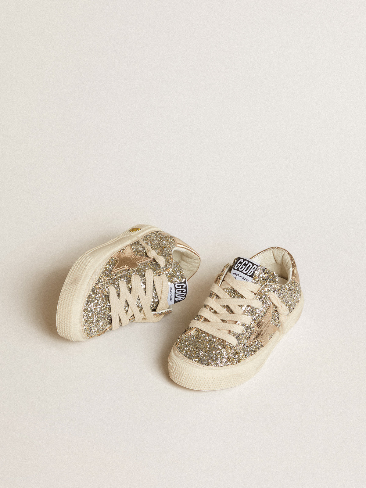 May Young in platinum glitter with metallic leather star and heel tab| Golden Goose