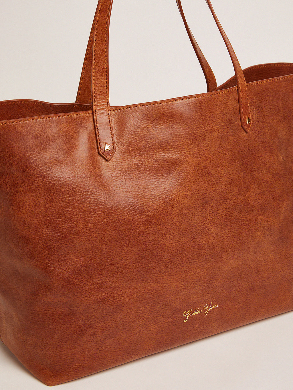 Pasadena Bag in tan-colored glossy leather with gold logo on the front| Golden Goose
