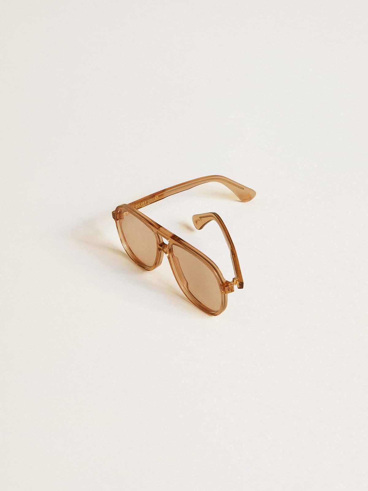 Aviator style sunglasses with honey-colored frame and lenses| Golden Goose