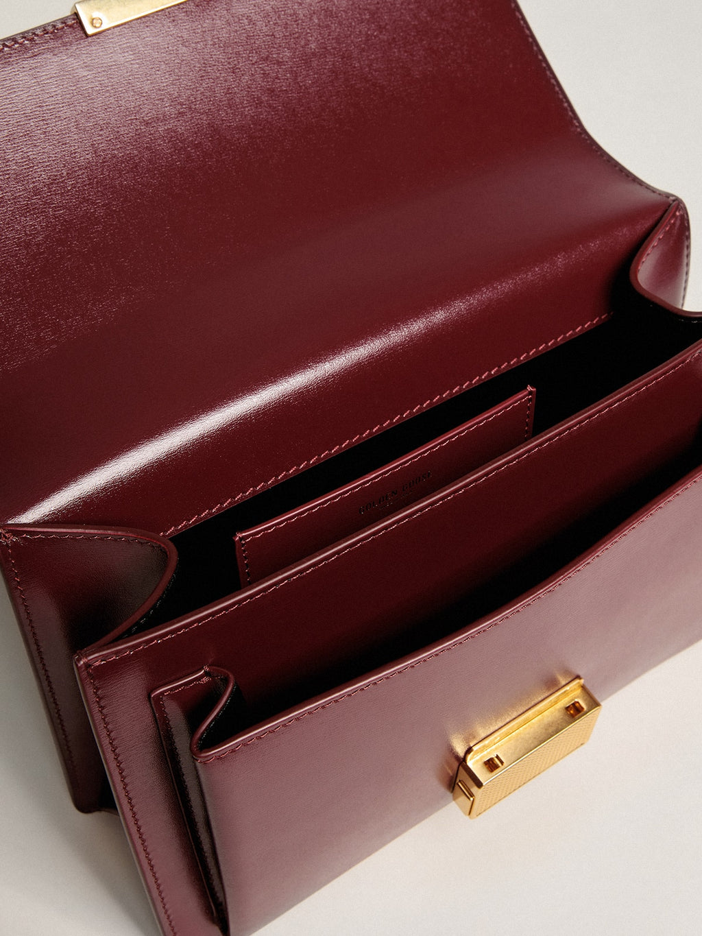 Venezia Bag in burgundy boarded leather with gold details| Golden Goose