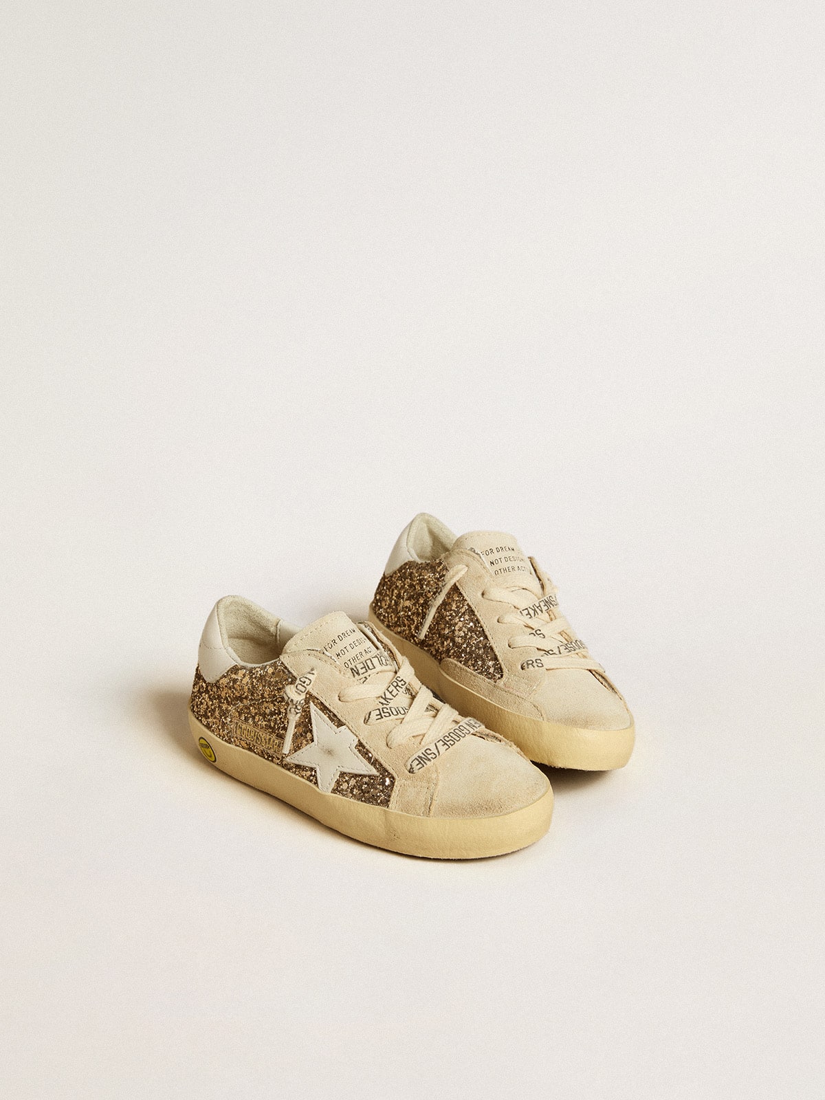 Super-Star Young in gold glitter with white leather star and heel tab| Golden Goose