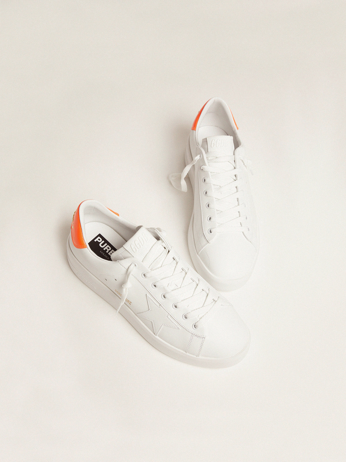 White Purestar sneakers with fluorescent orange heel tab| Golden Goose