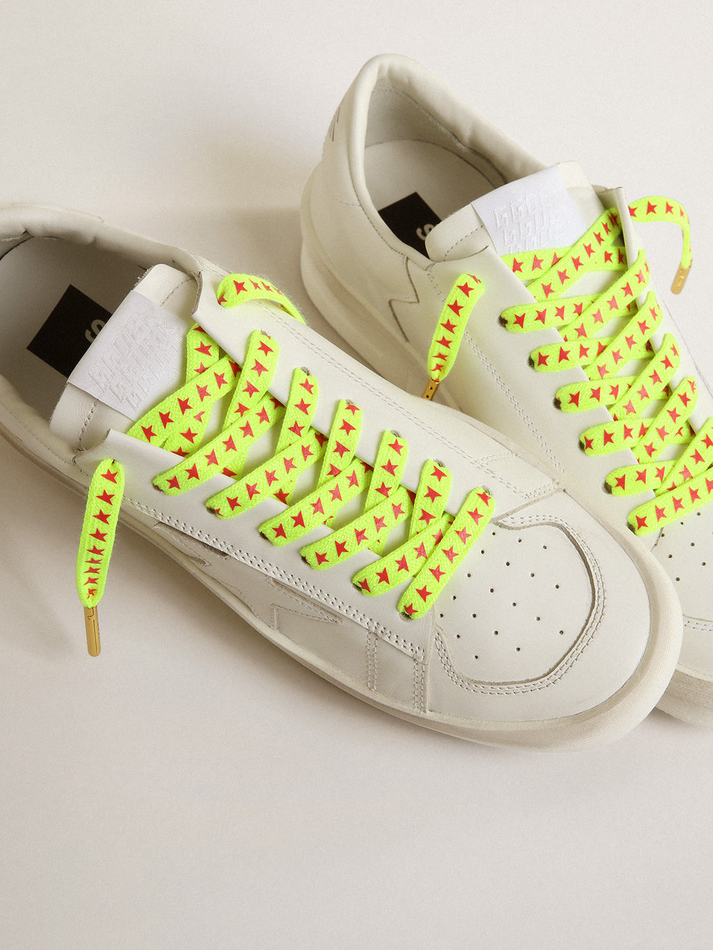 Fluorescent yellow laces with contrasting orange stars| Golden Goose