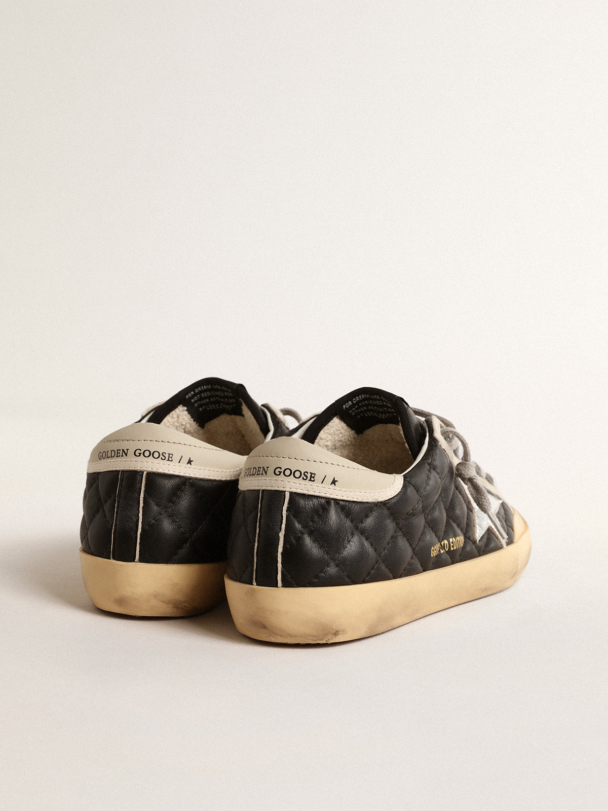 Super-Star Penstar in black matelassé nappa with silver star| Golden Goose