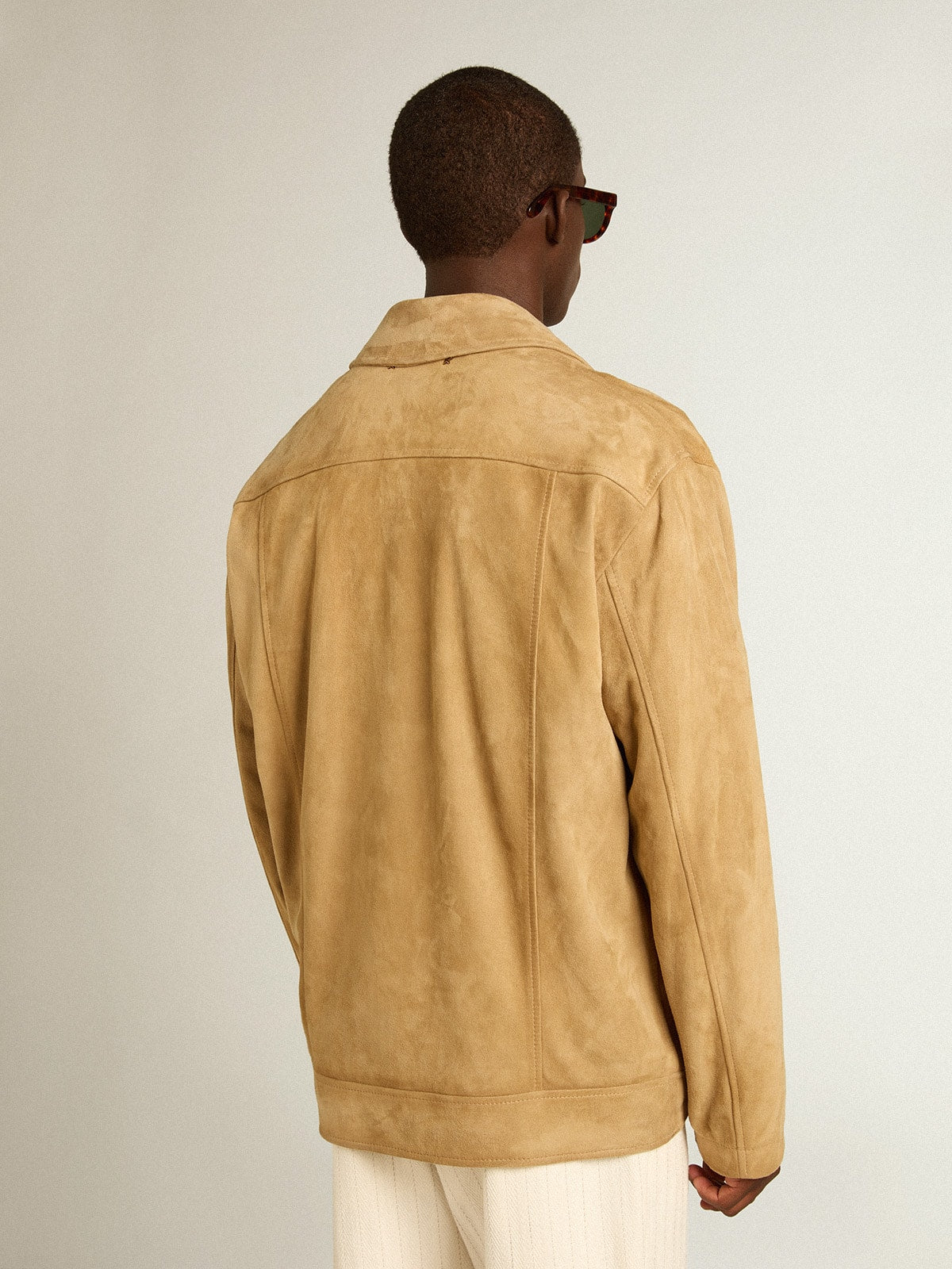 Beige-colored leather jacket with zip fastening