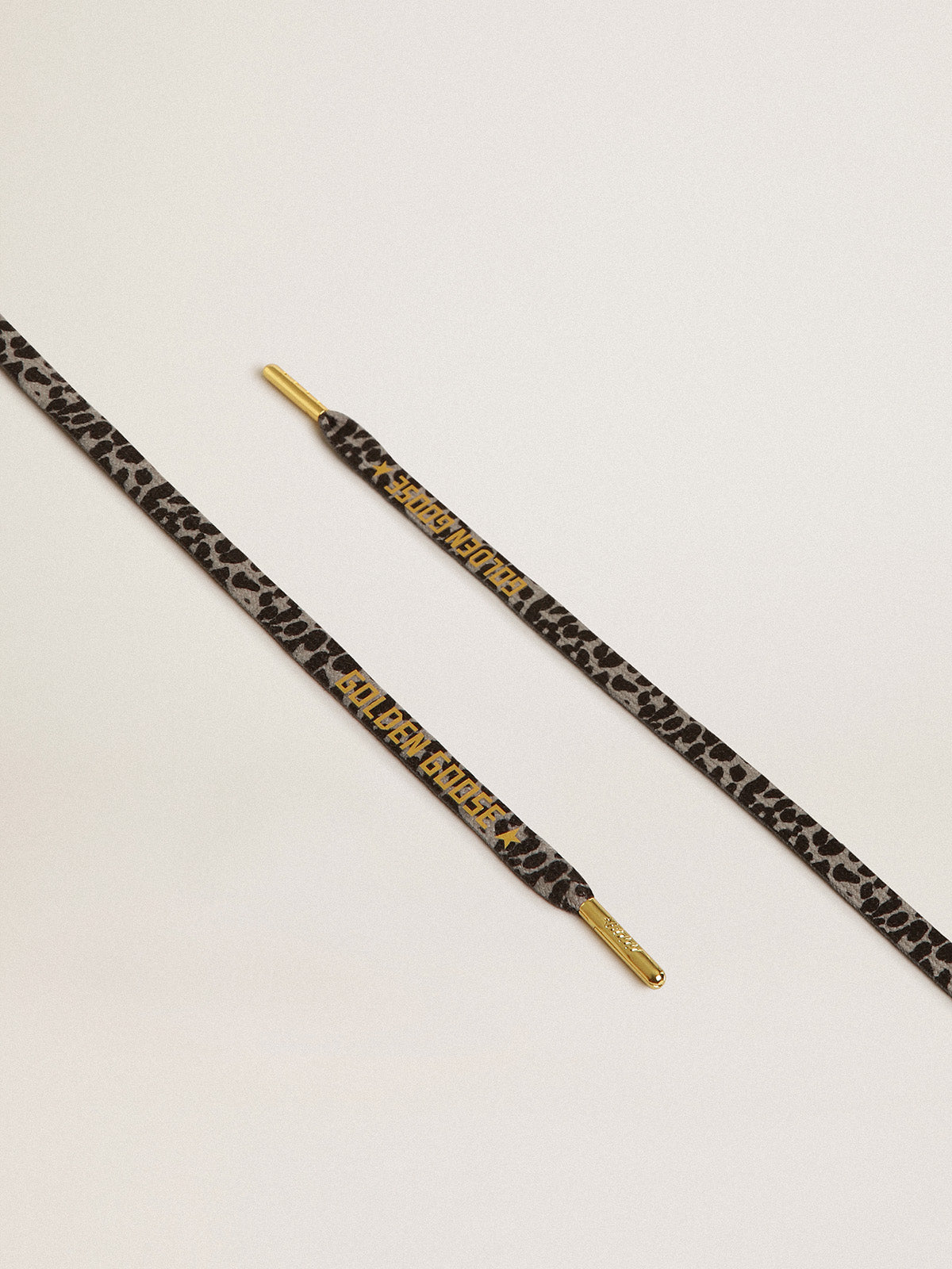Black and white animal-print laces with contrasting gold-colored logo| Golden Goose