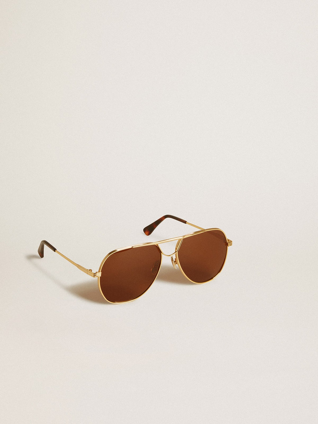 Aviator style sunglasses with gold frame and brown lenses| Golden Goose