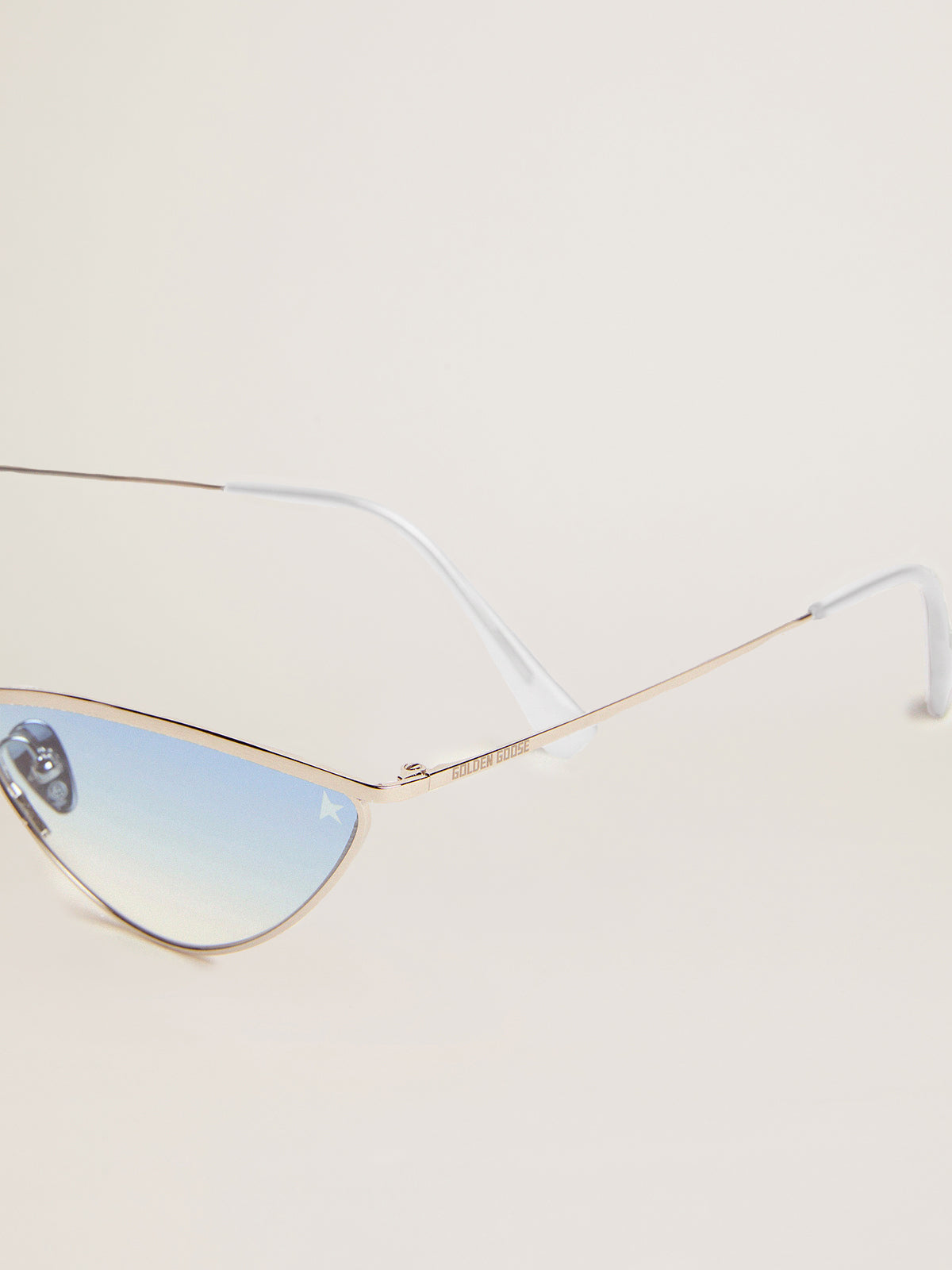 Sunglasses cat-eye style with silver frame and blue lenses| Golden Goose