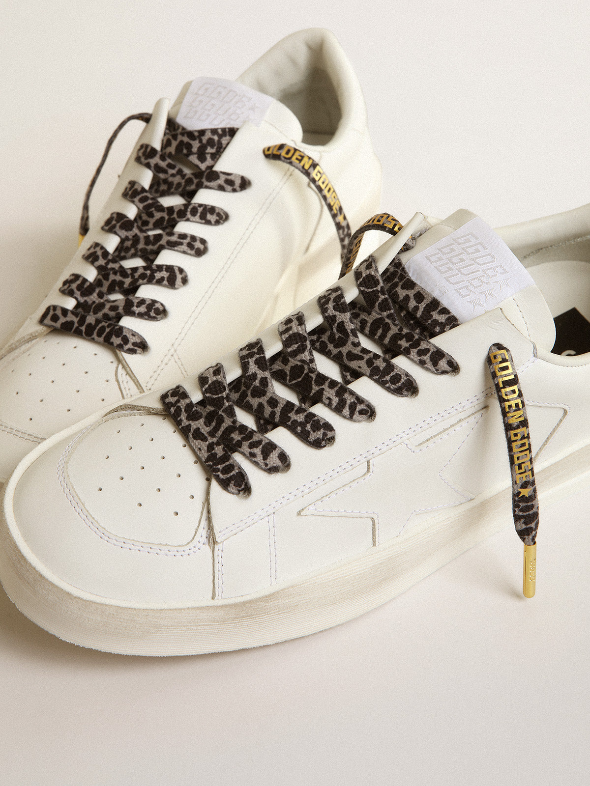 Black and white animal-print laces with contrasting gold-colored logo| Golden Goose