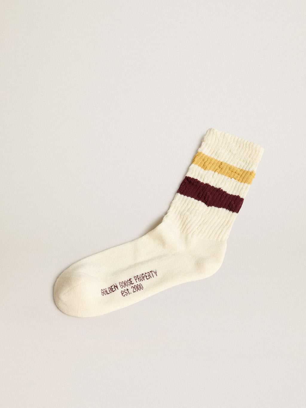 Worn white with distressed details and two-tone mustard and burgundy stripes| Golden Goose