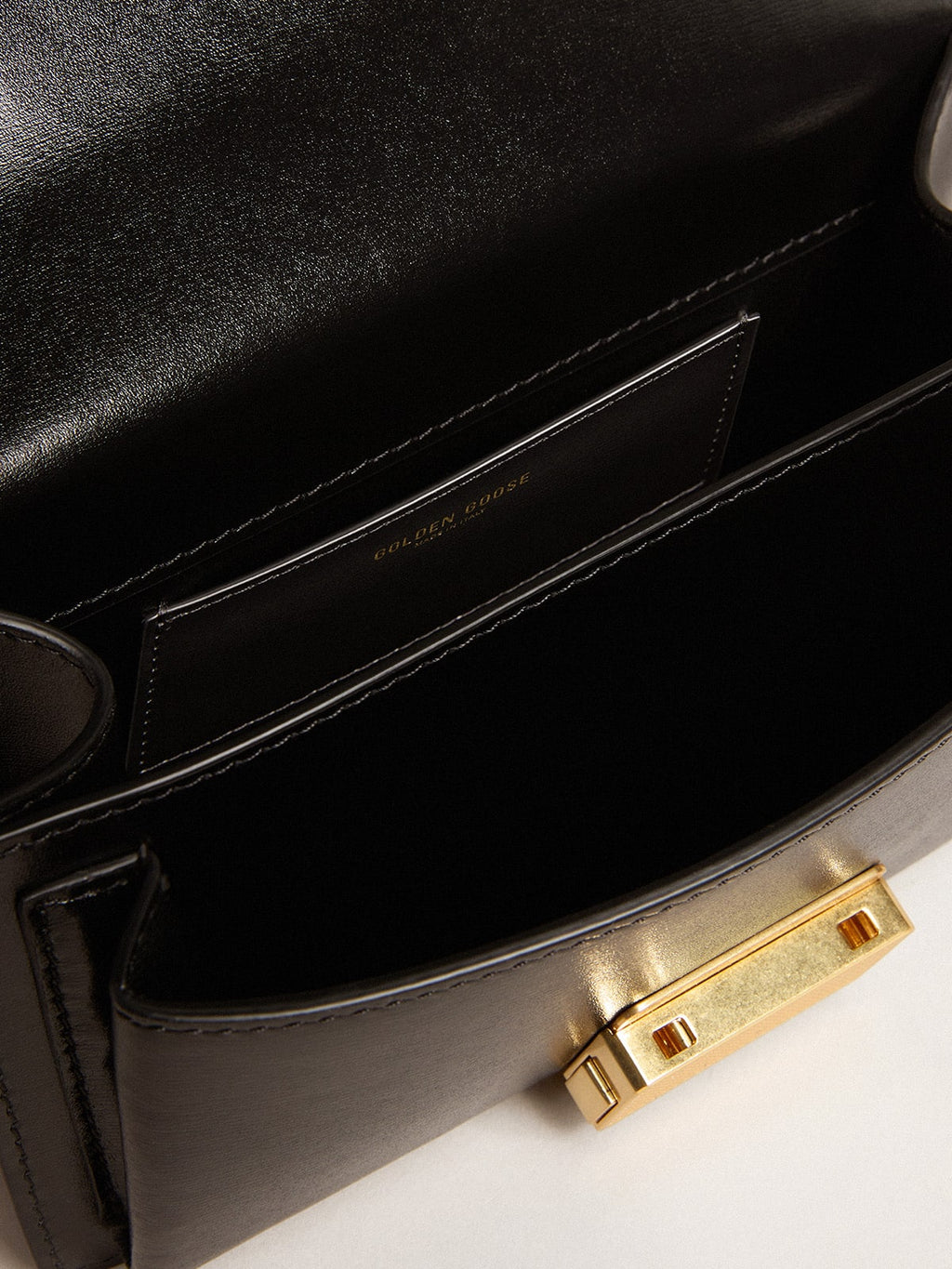 Small Venezia Bag in black boarded leather with gold details| Golden Goose