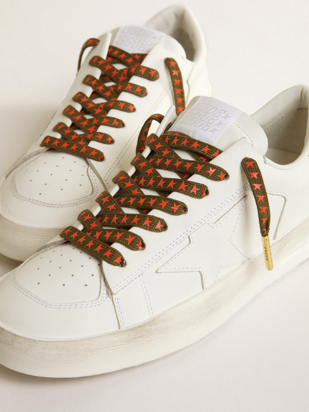 Military-green laces with contrasting orange stars| Golden Goose