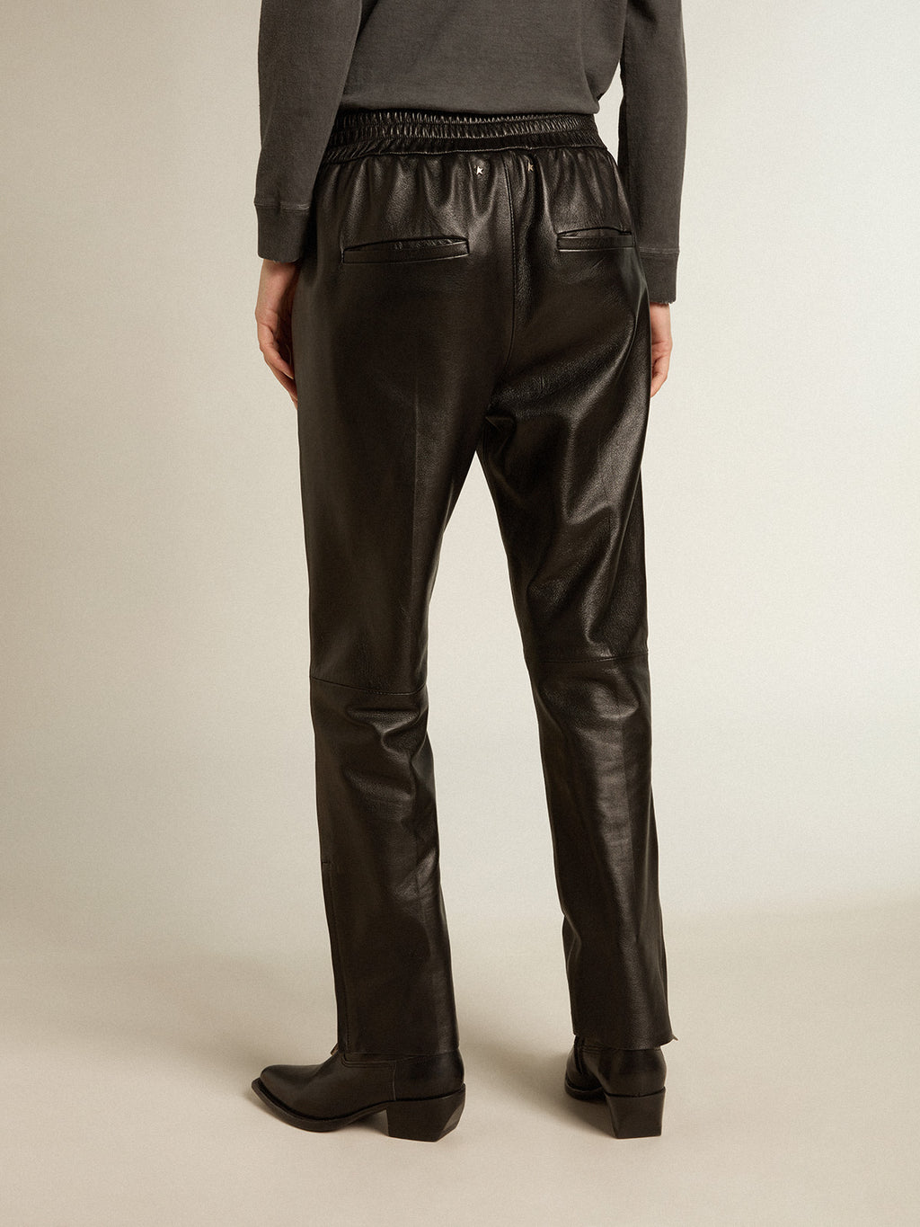 Black joggers in nappa leather with zip at the base| Golden Goose