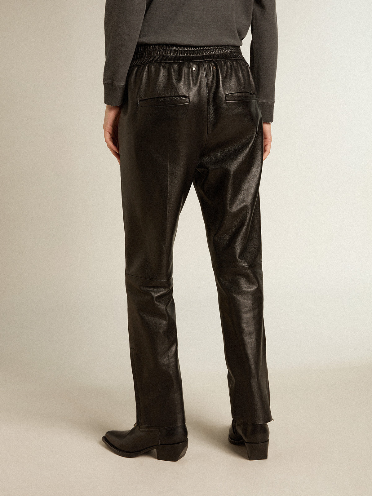 Black joggers in nappa leather with zip at the base| Golden Goose