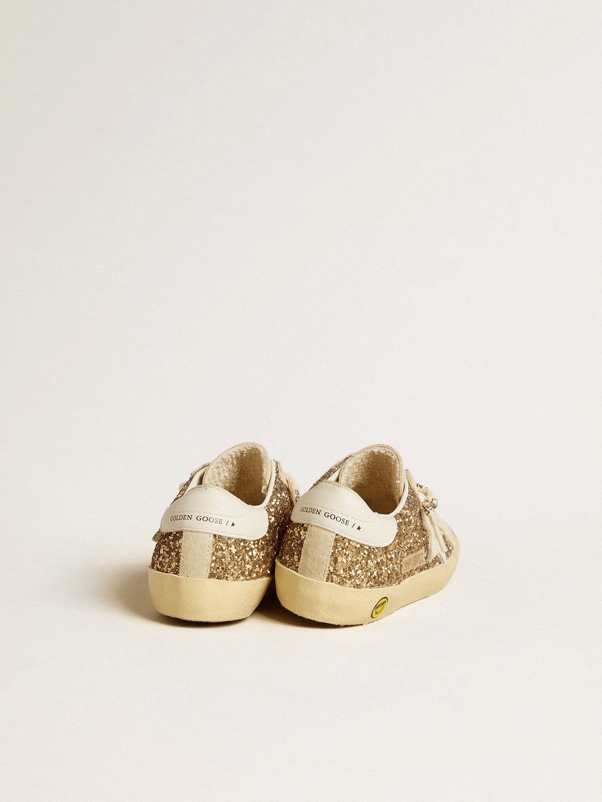 Super-Star Young in gold glitter with white leather star and heel tab| Golden Goose