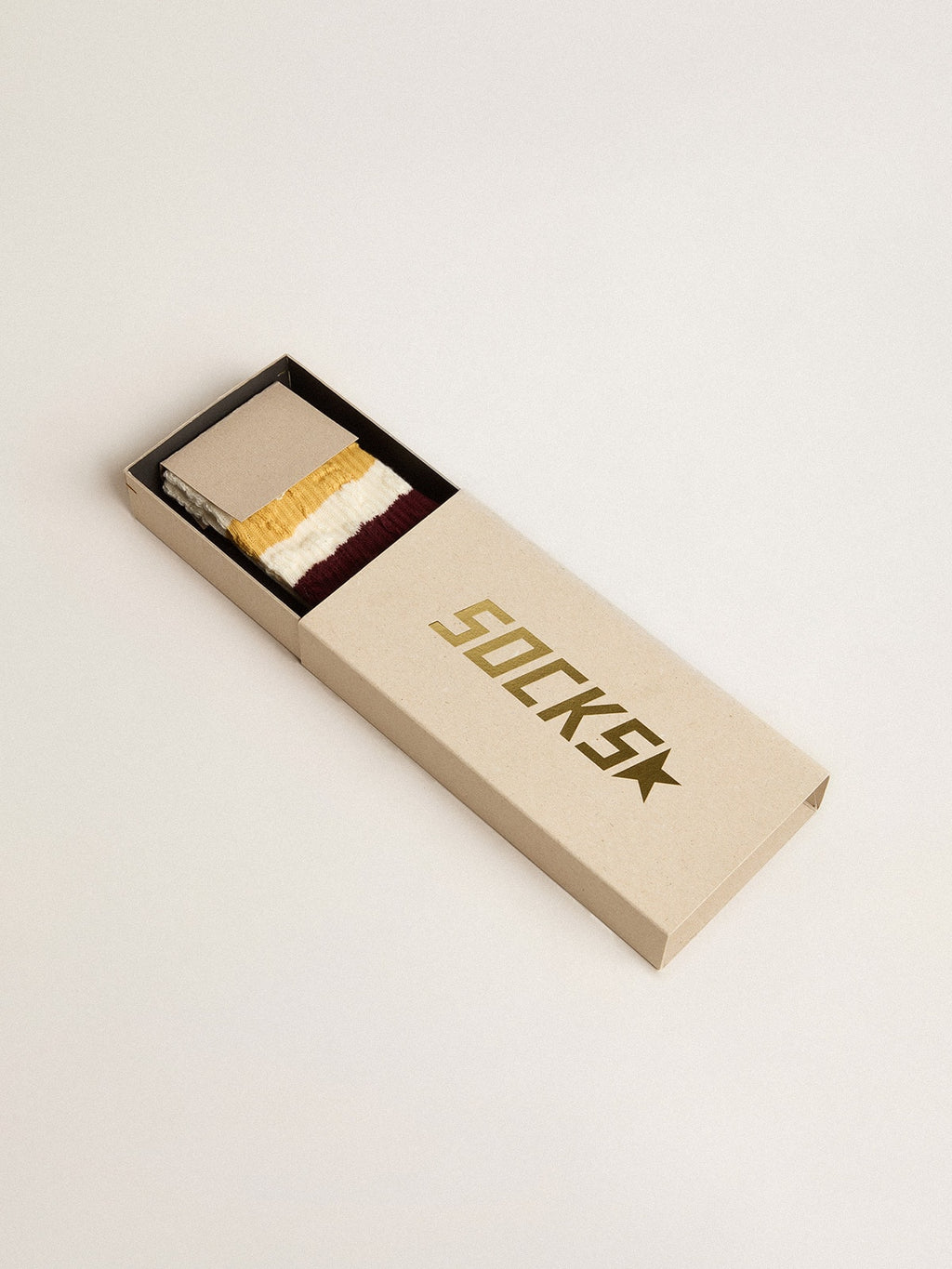 Worn white with distressed details and two-tone mustard and burgundy stripes| Golden Goose
