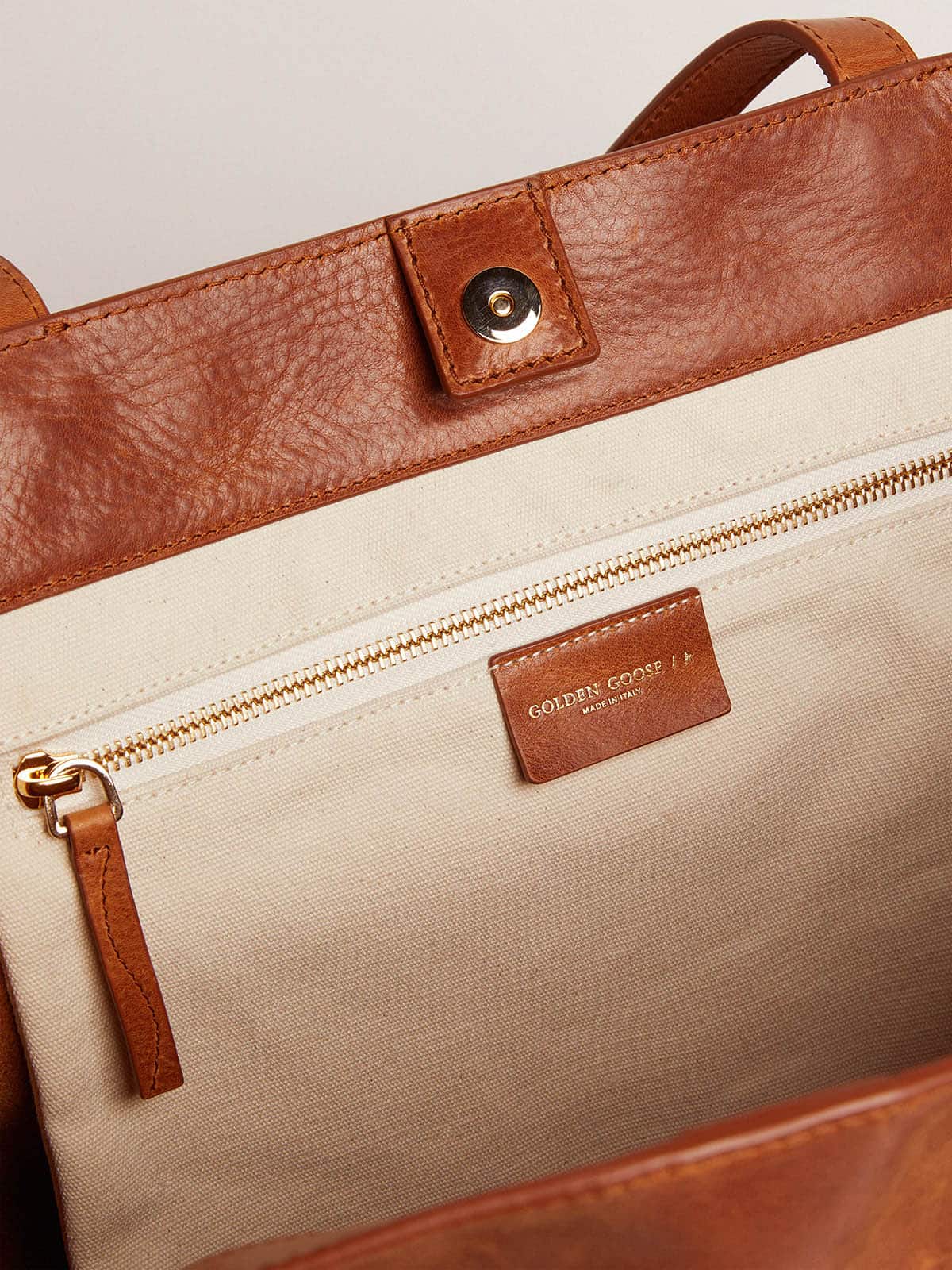 Pasadena Bag in tan-colored glossy hammered leather with gold logo on the front| Golden Goose