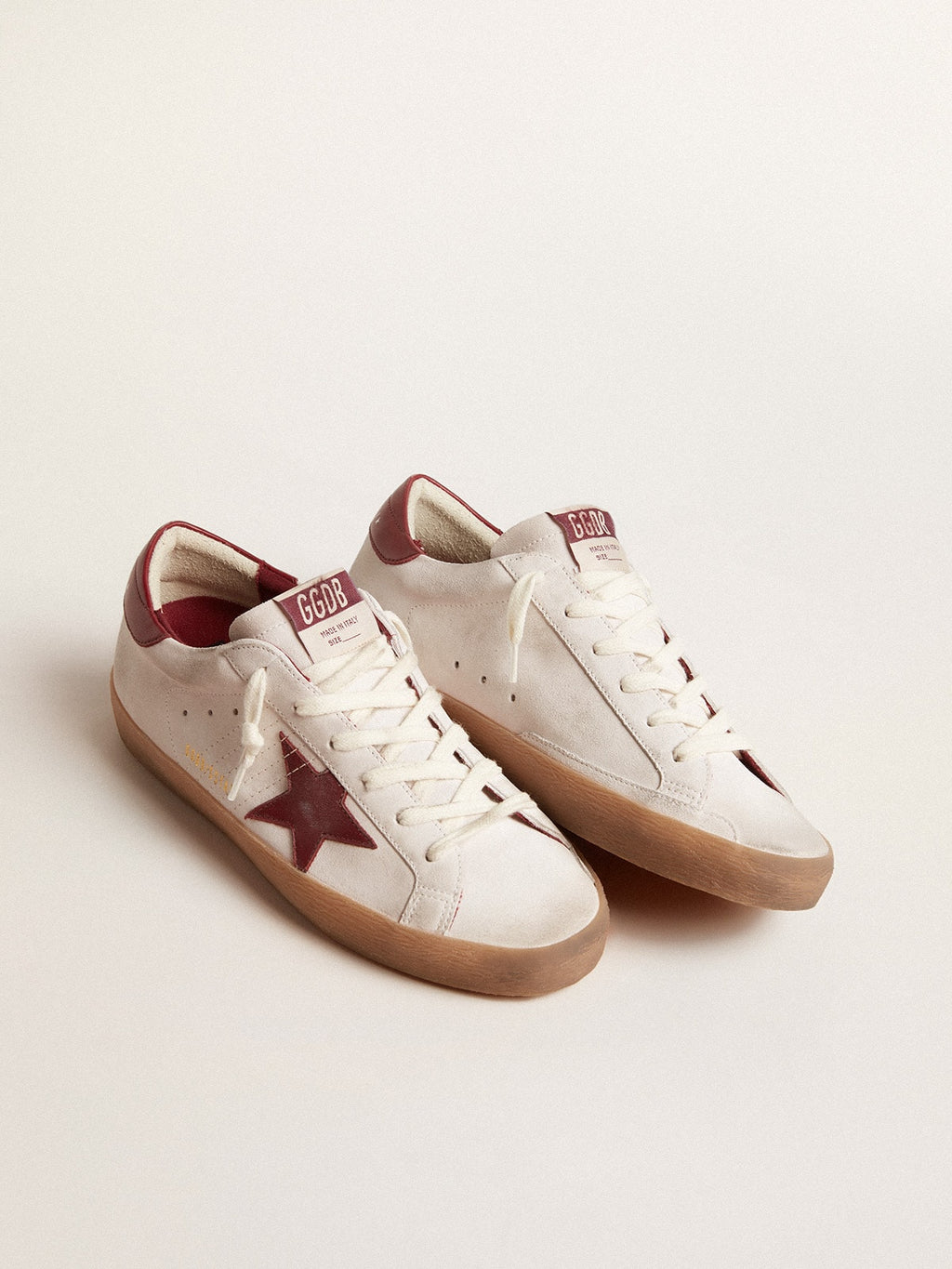 Super-Star in white suede with burgundy leather star and heel tab| Golden Goose