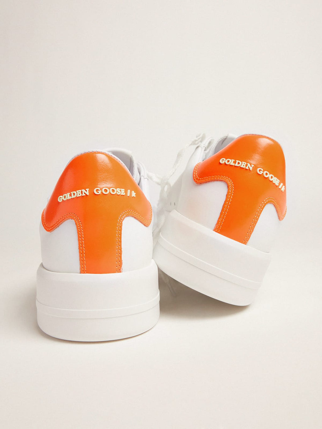 White Purestar sneakers with fluorescent orange heel tab| Golden Goose