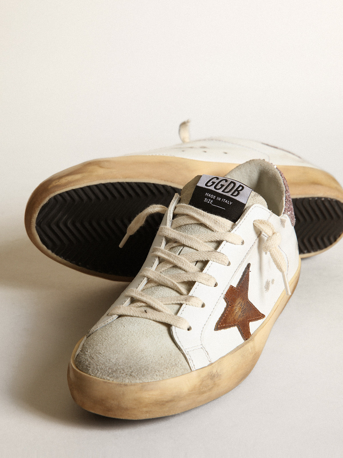 Super-Star with a tan star and pink glitter heel tab| Golden Goose